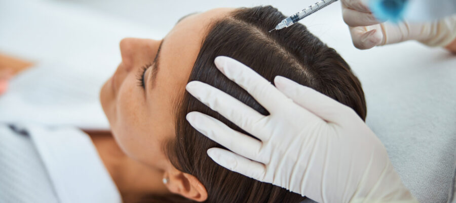 Young woman getting the serum scalp injection